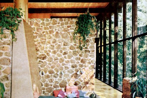 A conversation pit by a fireplace was the center of this two-story living room