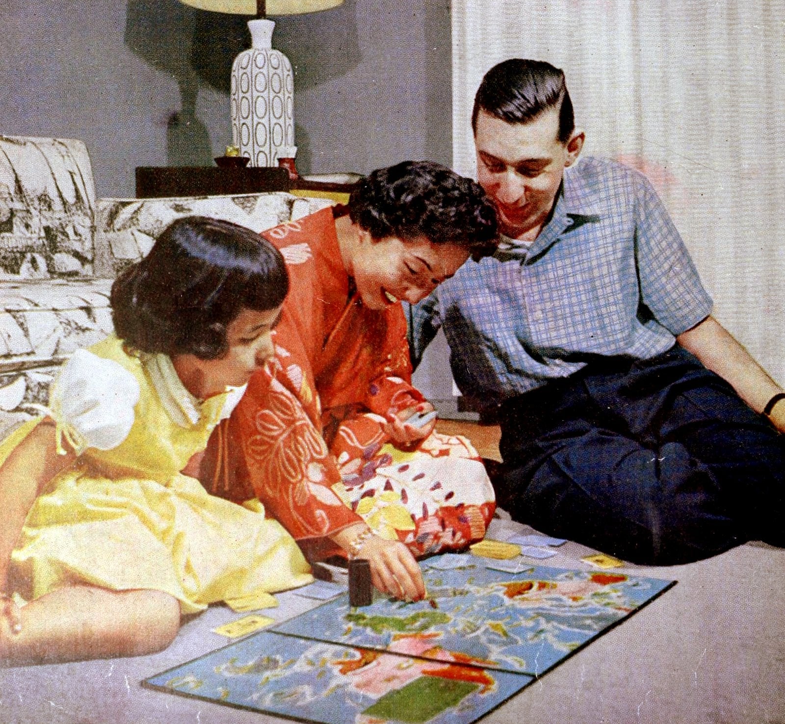 A post WW2 family playing a board game (1955) via ClickAmericana com