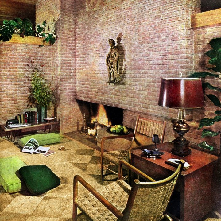 A sprawling brick fireplace wall defined this contemporary living room (1950s)