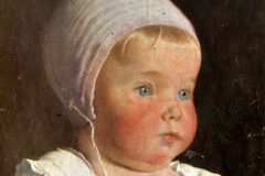 Baby from 1910s with bonnet on