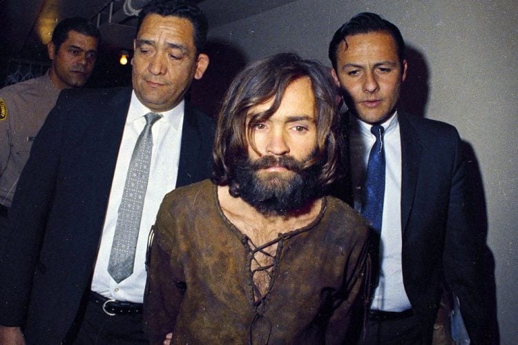 Image: Charles Manson being escorted to his arraignment on conspiracy-murder charges in 1969.