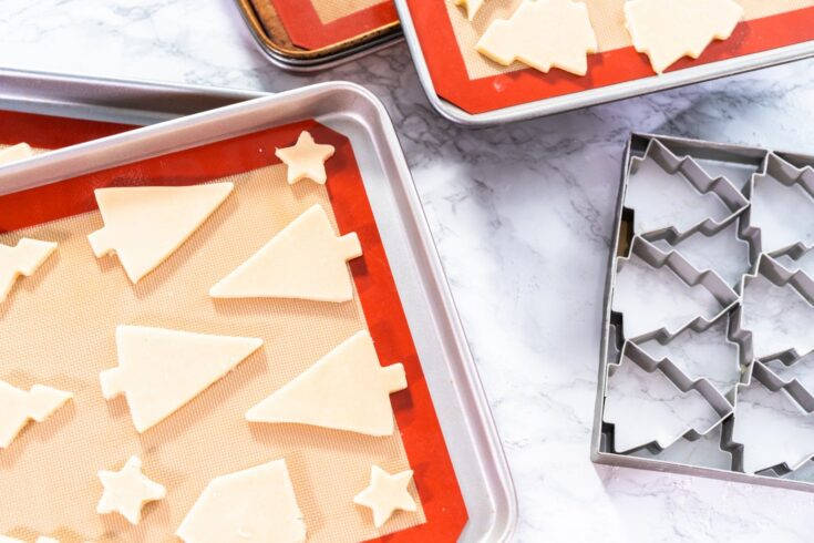 Cut out sugar cookies on a baking sheet