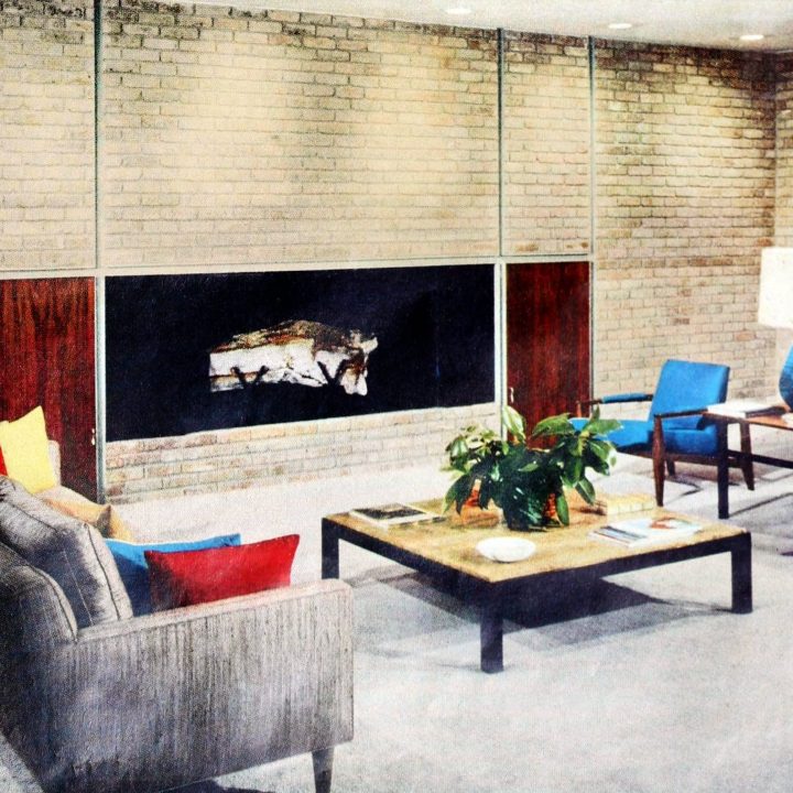 Flat brick fireplace wall dominated large midcentury modern living room