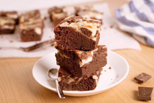 German chocolate cream cheese brownies in a stack of 3 on a plate