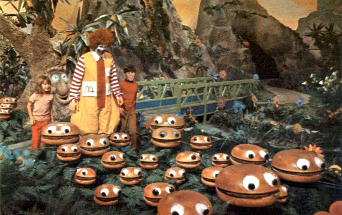 Old Ronald McDonalds with kids and a field of hamburgers
