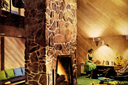 Retro lake view home two-sided stone fireplace living room