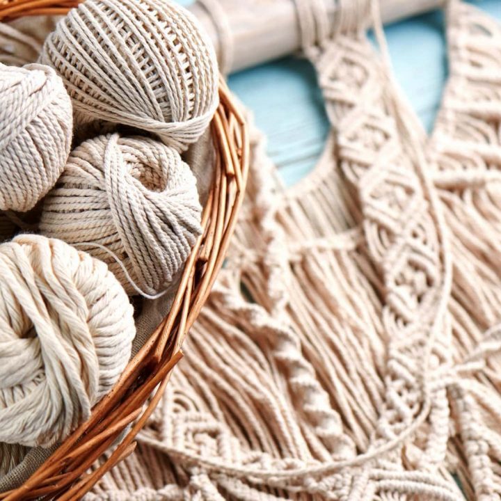 Handmade macrame braiding, background thread on a wooden Board top view