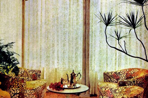 Sheer curtains filled this retro living room's tall window walls (1967)