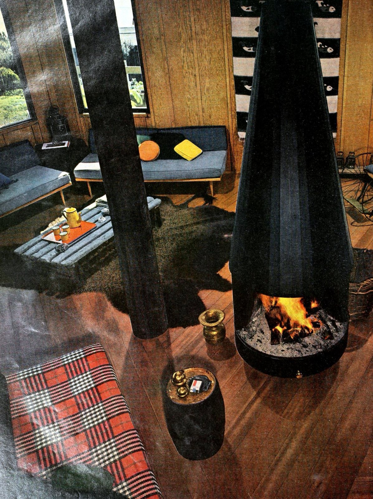 Stylish retro prefab fireplaces brought modern comfort to mid-century homes 1 Tall black cone-shaped ready-made fireplace (1963) via ClickAmericana com