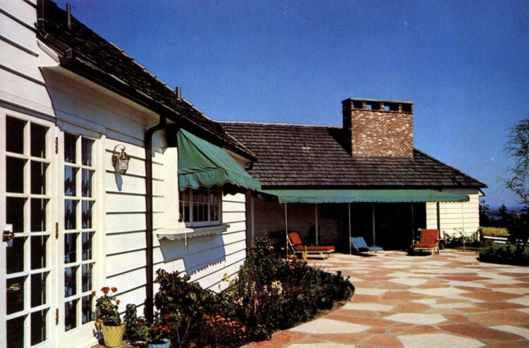 Vintage 1960s backyard patio with wide natural stone pavers