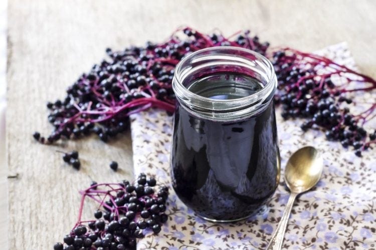 Homemade black elderberry syrup in glass jar
