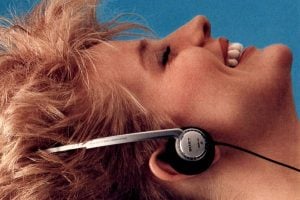 Woman listening to vintage Walkman stereo headphones