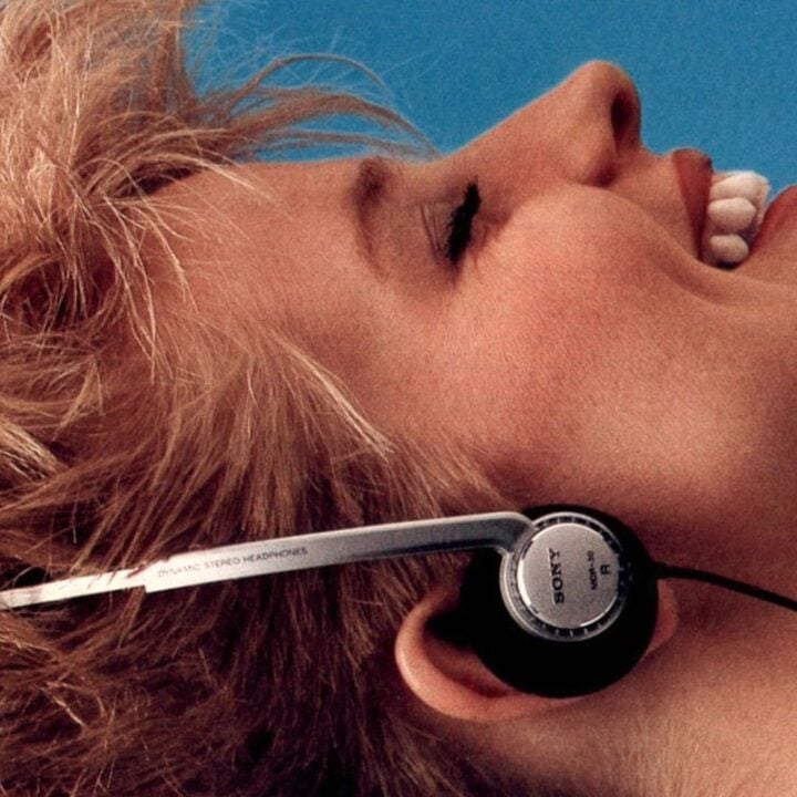 Woman listening to vintage Walkman stereo headphones