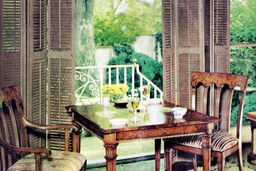 Wooden shutters perfectly framed this pretty little garden view dining area